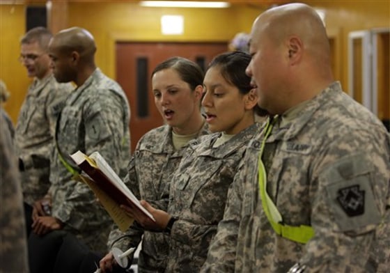 U.S. troops praying during a Christmas Eve mass in a chapel at an American military base in Baghdad, Iraq, Friday, Dec. 24, 2010. (AP Photo/Hadi Mizban)